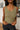 Close up view of model wearing the Moving Forward Tank which features green ribbed knit fabric, cropped waist and v neckline.