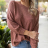 Close up view of model wearing the Just Relax Top In Marsala features brown fabric, a round neckline, and balloon long sleeves.