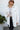 Front close up view of model wearing the Now Or Never Shacket which features cream fabric, geometric pattern, gunmetal button up closures, collared neckline, two front pockets, drop shoulders and balloon long sleeves with cuff button closures.