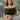 Front view of model wearing the Dancing Queen Top in Black, which has a black tulle material, a straight neckline with tulle detailing, a sleeveless design, and a side zipper closure