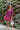 Frontal view of the Wanderlust Dress that features a wine colored silk material, a straight neckline, a puffy half sleeve, a smocked back, and a mini length.