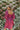 Back view of the Wanderlust Dress that features a wine colored silk material, a straight neckline, a puffy half sleeve, a smocked back, and a mini length.