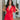 Frontal view of the Speechless Romper that features a red chiffon material, a surplice neckline, a short sleeve with a slit, a waist tie detail, a faux wrap skirt overlay, a shorts back, and a back zipper closure.