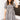 Front view of model wearing the Go Your Own Way Dress, which has a black and ivory plaid pattern, a straight neckline, a puffy half sleeve, pockets, a back zipper closure, and a mini length