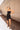 Full body front view of model wearing the Show Stopper Dress in Black, which features a black chiffon material, a straight neckline, a sleeveless design with thin straps, and a ruched overlapped detail on the skirt