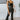 Front view of model wearing the Daily Ritual Faded Jeans, which have a stretchy denim material, a faded black wash, a flare leg fit, a high-rise waist, a five button closure, two front pockets, a frayed/distressed flare hem, and two back pockets