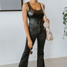 Front view of model wearing the Daily Ritual Faded Jeans, which have a stretchy denim material, a faded black wash, a flare leg fit, a high-rise waist, a five button closure, two front pockets, a frayed/distressed flare hem, and two back pockets