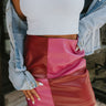 Frontal view of the Born Diva Color-Block Skirt that features a faux leather material, a color block design, a high-rise waist, and a back zipper closure