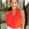 Frontal view of the Seeing Red Halter Bodysuit that features a red chiffon material, a deep V surplice neckline, halter straps with a neck tie, an open back, a bikini bottom, and a snap closure.