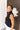 Side view of the Meet Me In Maine Sweater Tank that features a black stretchy knit material, a turtleneck, a sleeveless design, and a thick bottom hem.