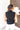 Back view of the Meet Me In Maine Sweater Tank that features a black stretchy knit material, a turtleneck, a sleeveless design, and a thick bottom hem.