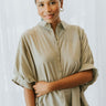 Frontal view of the Summer Chapter Top that features an olive colored material, a collared neckline, an oversized half sleeve, and a button down front.