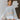 Frontal view of the Cozy Nights Sweater that features a multi-colored knit material, a round neck, a long oversized sleeve, and a flowy fit.