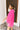 Side view of the Summer Chapter Top that features a hot pink colored material, a collared neckline, an oversized half sleeve, and a button down front.