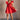 Full body front view of model wearing the Ava Red Ruffle Bow-Back Mini Dress that has red cotton fabric, mini length, flare skirt, pockets on each side, a sweetheart neck, ruffle straps, and an open back with tie closures.