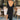 Full body back view of model wearing the Date Night Midi Dress, that has black ribbed knit fabric, a plunge back with pearl and rhinestone trim, a high round neckline, long fitted sleeves, a side slit.