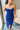 Close-up front view of model wearing the Turn Back Time Midi Dress, which features lined navy fabric, a strapless corset top with boning in the front, a front slit, and a back zipper