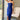 Front view of model wearing the Turn Back Time Midi Dress, which features lined navy fabric, a strapless corset top with boning in the front, a front slit, and a back zipper