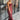 Front view of model wearing the Magic Moment Dress in Burgundy, which features satin fabric with a midi-length hem, burgundy feathers across the neckline, adjustable thin straps, and a back zipper