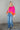 Full body front view of model wearing the Noa Color Block Long Sleeve Sweater that has a pink, yellow, and orange color block pattern, long balloon sleeves with ribbed wrists, a round neckline, and oversized fit.