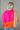 Back view of model wearing the Noa Color Block Long Sleeve Sweater that has a pink, yellow, and orange color block pattern, long balloon sleeves with ribbed wrists, a round neckline, and oversized fit.