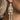 Side view of model wearing the Sally White Glitter Skeleton Earrings that feature white glitter skeleton shaped dangle earrings with gold link details.