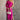 Full body front view of model wearing the Dahlia Pink One-Shoulder Ruched Midi Dress that has lightweight pink knit fabric, a one-shoulder neckline with 1 long sleeve, a back cutout, ruched sides, and a side slit.