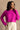 Front view of model wearing the Aria Fuchsia Long Sleeve Sweater which features fuchsia textured knit fabric, ribbed trim, a cropped waist, a round neckline, dropped shoulders, and long sleeves with ribbed trim.