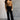 Full body view of model wearing the Aubrey Black Lounge Pants which features black cotton fabric, two front pockets, an elastic waistband with drawstring ties, and wide legs.