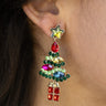 Close-up of model wearing the Christmas Tree Multi-Color Stone Earrings that have multi-colored stones forming a Christmas Tree shape with green stars on post backs and red gift pendants.
