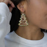 Side view of model wearing the Christmas Tree Beaded Earrings that feature gold Christmas trees with a green beaded outline and red, orange, and green beaded interiors.