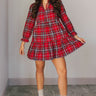 Full body view of model wearing the Victoria Red Multi Plaid Tiered Mini Dress which features red cotton fabric with a dark blue, light blue, green and white plaid pattern, mini length, two-tiered body style, a round neckline with a v cut-out, a tie closu