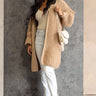 Full body front view of model wearing the Jayla Taupe Open Front Cardigan that has taupe cable knit fabric, an open front, dropped shoulders, a thigh length hem, and long bubble sleeves.