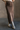 Front view of model wearing the Angela Brown Front Slit Midi Skirt which features brown cotton fabric, midi length, front slit detail, front zipper with button closure, belt loops, two front pockets, two back pockets and fray hem.