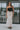 Full body front view of model wearing the Trend Setter Cargo Midi Skirt that has taupe light weight fabric, side cargo pockets, an elastic waist with a black drawstring tie, two upper pockets and a back slit