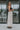 Full body side view of model wearing the Trend Setter Cargo Midi Skirt that has taupe light weight fabric, side cargo pockets, an elastic waist with a black drawstring tie, two upper pockets and a back slit