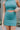 Close front view of model wearing the Get Obsessed Skort in Teal that has teal fabric, a mini length hem, shorts lining, and an overlapped waistline.