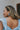 Side view of model wearing the Blue Skies and More Hoops which features open, large hoops with light blue acrylic.