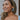 Side view of model wearing the Blue Skies and More Hoops which features open, large hoops with light blue acrylic.