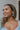 Side view of model wearing the Blue Skies and More Hoops which features open, large hoops with light blue acrylic.