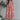 Full body view of model wearing the Secret Garden Midi Dress which features purple, red, orange, pink, yellow, green, teal and white fabric, floral print, midi length, flare hem, square neckline, short puff sleeves and smocked back.