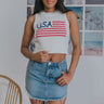 Front view of model wearing the All American Girl Tank which features white, red and blue knit fabric, American Flag design with "USA" wording, round neckline and sleeveless.