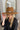 The Blame My Roots Hat is a wide brim hat featuring a camel colored fabric and a silver belt, finished with adjustable ties within for different fits.