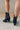 Heel view of the Zane Western Bootie features a black leather upper, an almond toe, western inspired embroidery through out, side pull tabs for easy entry/exit, and a 3" block heel.
