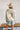 Back view of the Fast Forward Sweater that features an ivory knit material with a taupe design, a round neckline, a long sleeve, and an oversized fit.