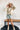 Frontal view of the Fast Forward Sweater that features an ivory knit material with a taupe design, a round neckline, a long sleeve, and an oversized fit.