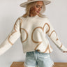 Frontal view of the Fast Forward Sweater that features an ivory knit material with a taupe design, a round neckline, a long sleeve, and an oversized fit.