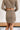 Back view of the It Takes Two Skirt that features a beige colored tweed material, a brown and black gingham print, a high-rise fit, a thick waist band, a curved bottom hem, a side zipper closure, and a mini length.