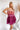 Frontal view of the Pinky Promise Mini Dress that features a tulle material, a monochromatic tiered design, a straight neckline, a sleeveless design with thin adjustable straps, a back zipper closure, and a mini length.