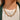 The Meet Me In The Middle Necklace In Green is a multi-layered necklace featuring green jewel pendants through out finished with a link and clasp closure.
